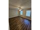 Large bedroom with ceiling fan, wood-look floors, and two windows at 4670 Eberline Ct, Stone Mountain, GA 30083