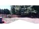 Large backyard with wooden fence and mature trees at 221 Bridgemill Ln, Hampton, GA 30228