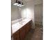 Clean bathroom with vanity and wood-look floors at 221 Bridgemill Ln, Hampton, GA 30228