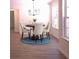 Charming dining room with round table and blue rug at 221 Bridgemill Ln, Hampton, GA 30228