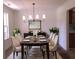 Elegant dining room with a large table and modern chandelier at 221 Bridgemill Ln, Hampton, GA 30228