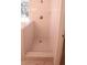Modern walk-in shower with penny round tile floor at 221 Bridgemill Ln, Hampton, GA 30228