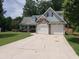 Two-story house with a two-car garage and driveway at 221 Bridgemill Ln, Hampton, GA 30228
