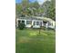 Light green house with black shutters and a grassy lawn at 939 Beecher Sw Ct, Atlanta, GA 30311