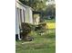 Side view of a light green house with landscaping and a lawn at 939 Beecher Sw Ct, Atlanta, GA 30311