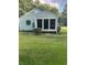 Light green house exterior with sunroom at 939 Beecher Sw Ct, Atlanta, GA 30311