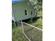 Rear view of a light green house with a chain link fence at 939 Beecher Sw Ct, Atlanta, GA 30311