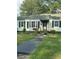 Light green house with black shutters and a small front yard at 939 Beecher Sw Ct, Atlanta, GA 30311