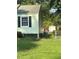 Side view of a light green house with a chain link fence at 939 Beecher Sw Ct, Atlanta, GA 30311