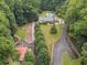 House nestled in wooded lot with a pool and long driveway at 3992 Doc Sams Rd, Cumming, GA 30028