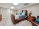 Finished basement bedroom with plush bedding and sitting area at 3992 Doc Sams Rd, Cumming, GA 30028