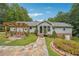 Ranch style home with stone walkway, pergola and landscaping at 3992 Doc Sams Rd, Cumming, GA 30028