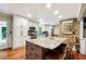 Updated kitchen with island, granite countertops, and stainless steel appliances at 3992 Doc Sams Rd, Cumming, GA 30028