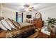 Spacious bedroom with hardwood floors, ceiling fan, and large dresser at 3992 Doc Sams Rd, Cumming, GA 30028