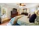 Main bedroom with hardwood floors, large bed, and ensuite bathroom at 3992 Doc Sams Rd, Cumming, GA 30028