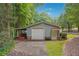 Detached workshop with large overhead door and covered storage area at 3992 Doc Sams Rd, Cumming, GA 30028
