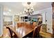 Formal dining room with chandelier and view into the living room at 3992 Doc Sams Rd, Cumming, GA 30028