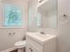 Bathroom with toilet, sink, and large mirror at 2666 Blount St, Atlanta, GA 30344