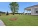 Landscaped backyard with lush grass, a tree, and a view of the neighborhood at 2711 Tomich Sw Ave, Powder Springs, GA 30127