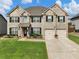 Two-story brick home with landscaping and two-car garage at 90 Piedmont Cir, Covington, GA 30016