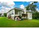 Back of house features sunroom, deck, and detached garage at 37 Red Fox Trl, Euharlee, GA 30145