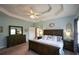Main bedroom with tray ceiling, large bed, and dresser at 37 Red Fox Trl, Euharlee, GA 30145