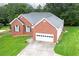 Brick house with attached garage, large yard, and tree-lined property at 37 Red Fox Trl, Euharlee, GA 30145