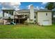 Back of house, showcasing a large deck and sunroom addition at 37 Red Fox Trl, Euharlee, GA 30145