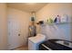 Bright laundry room, washer, dryer, and shelving for storage at 37 Red Fox Trl, Euharlee, GA 30145