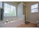 Bathroom with garden tub, shower, and large window at 37 Red Fox Trl, Euharlee, GA 30145