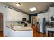 Kitchen features white cabinets, stainless steel appliances, and hardwood floors at 37 Red Fox Trl, Euharlee, GA 30145