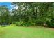 Large backyard with trampoline and mature trees at 37 Red Fox Trl, Euharlee, GA 30145