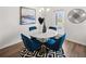 Bright dining area with a round marble table and four blue velvet chairs at 204 Epping Street # 2, Stockbridge, GA 30281