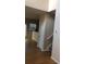 Hardwood floor hallway with staircase and storage closet at 585 Mcwilliams Se Rd # 2307, Atlanta, GA 30315