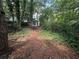 Path through a wooded backyard leading to a shed at 1003 Edie Se Ave, Atlanta, GA 30312