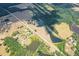 Aerial view showing a house, pond, and surrounding land at 1875 Highway 142, Covington, GA 30014