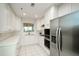 Modern kitchen with white cabinets, stainless steel appliances, and tile flooring at 211 Colonial Homes Dr # 2304, Atlanta, GA 30309