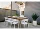 Modern patio with a large wooden dining table and white chairs at 10 Spirea Way, Auburn, GA 30011