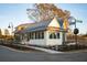 White cottage with gray metal roof and black windows at 52 Spirea Way, Auburn, GA 30011