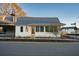Cute cottage with gray metal roof and peach front door at 52 Spirea Way, Auburn, GA 30011