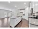 Open kitchen with island, granite countertops, stainless steel appliances, and dark hardwood floors at 5586 Cannonade Ln, Stonecrest, GA 30058
