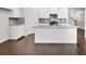 Modern kitchen featuring a large island with granite countertops and white cabinetry at 5586 Cannonade Ln, Stonecrest, GA 30058