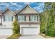 Two-story townhome with attached garage and landscaping at 5586 Cannonade Ln, Stonecrest, GA 30058