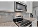 Stainless steel microwave above stovetop at 5586 Cannonade Ln, Stonecrest, GA 30058