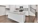 Kitchen island with granite countertop, double sink, and white cabinets at 5586 Cannonade Ln, Stonecrest, GA 30058