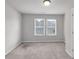 Simple bedroom with two windows and neutral walls at 5586 Cannonade Ln, Stonecrest, GA 30058