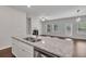 Kitchen island with granite countertops and double sink overlooking living room at 5586 Cannonade Ln, Stonecrest, GA 30058