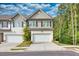 Two-story townhome with attached garage and landscaping at 5586 Cannonade Ln, Stonecrest, GA 30058