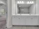 Double vanity bathroom with a large mirror and view into the shower at 5586 Cannonade Ln, Stonecrest, GA 30058