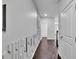 Hallway with dark hardwood floors and an accent wall at 5586 Cannonade Ln, Stonecrest, GA 30058